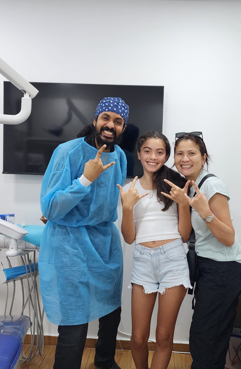 Dr. Keerthan with two patients, all smiles