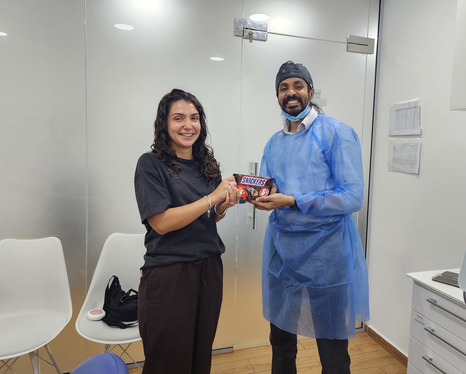 Dr. Keerthan and a patient sharing a thank-you treat