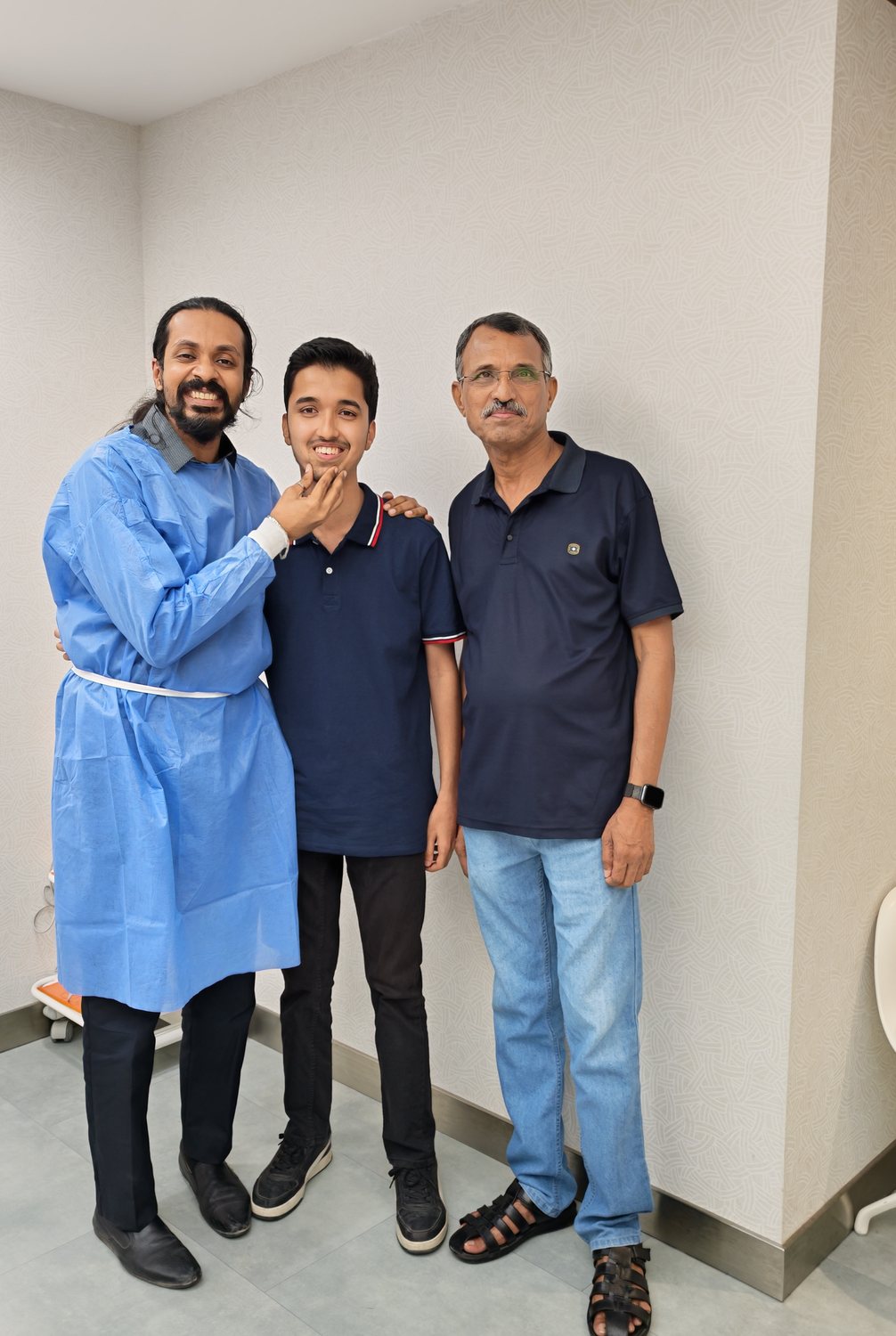 Dr. Keerthan with a patient and family member