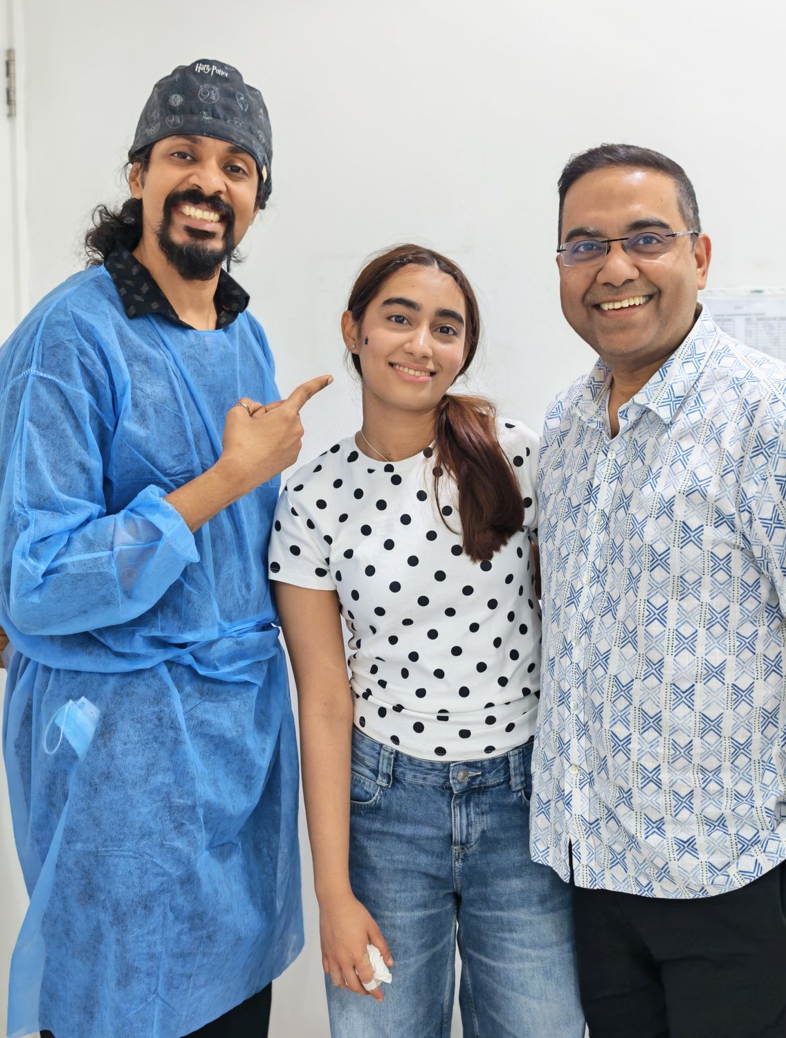 Dr. Keerthan with a patient and a family member