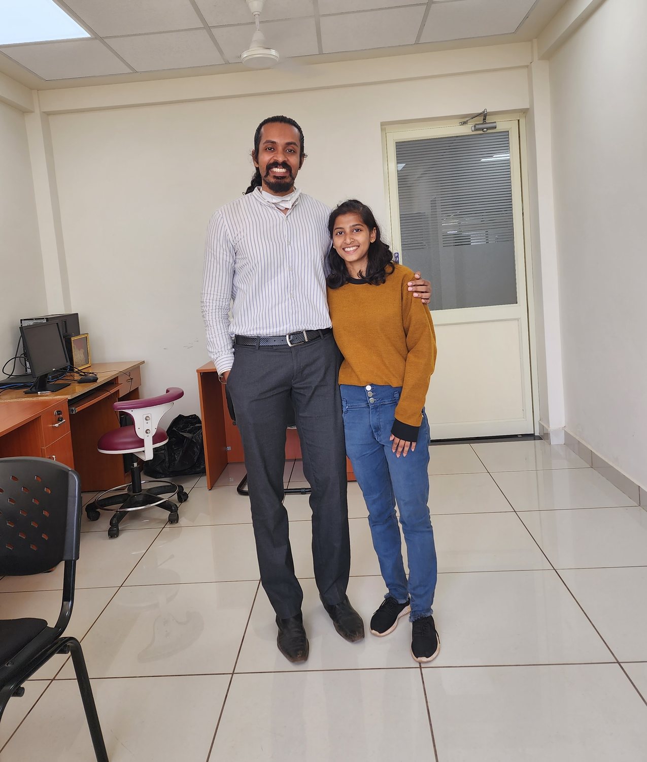 Dr. Keerthan with a patient on their last day of treatment