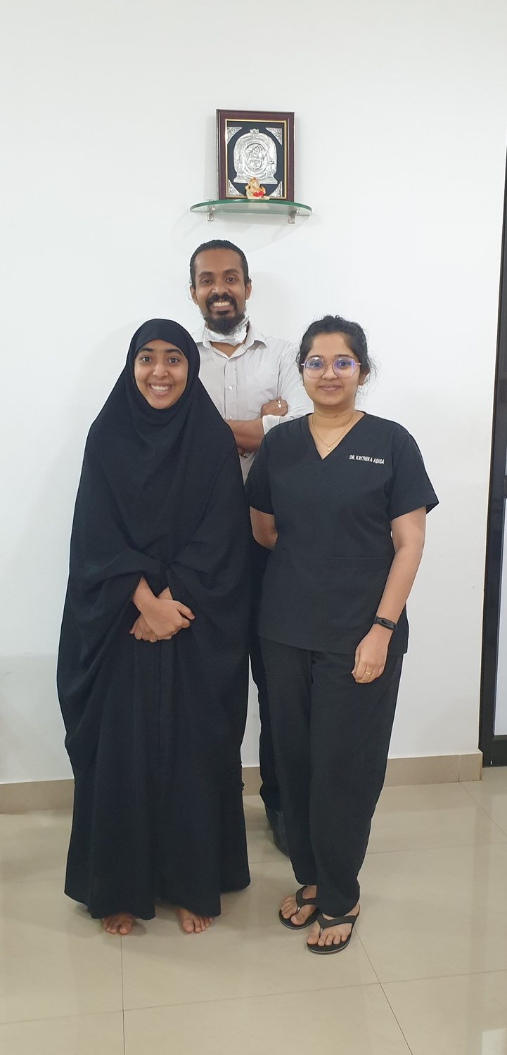 Dr. Keerthan with a patient on their last day of treatment