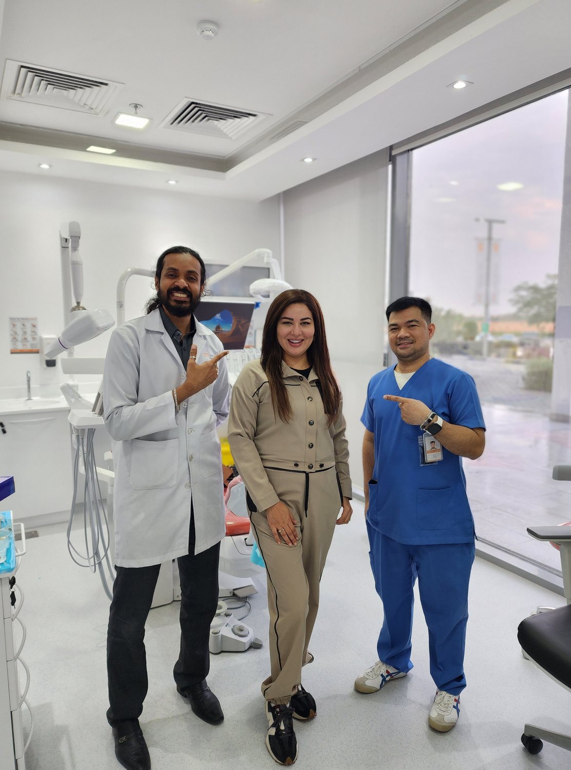 Dr. Keerthan with a patient on their last day of treatment