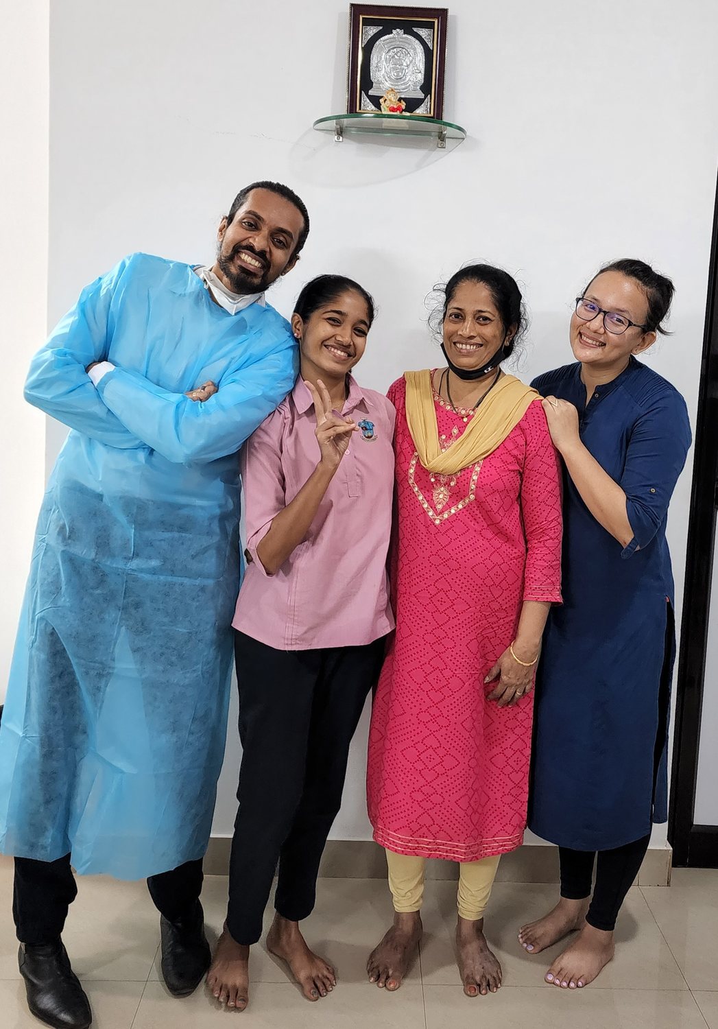 Dr. Keerthan with three patients at the clinic