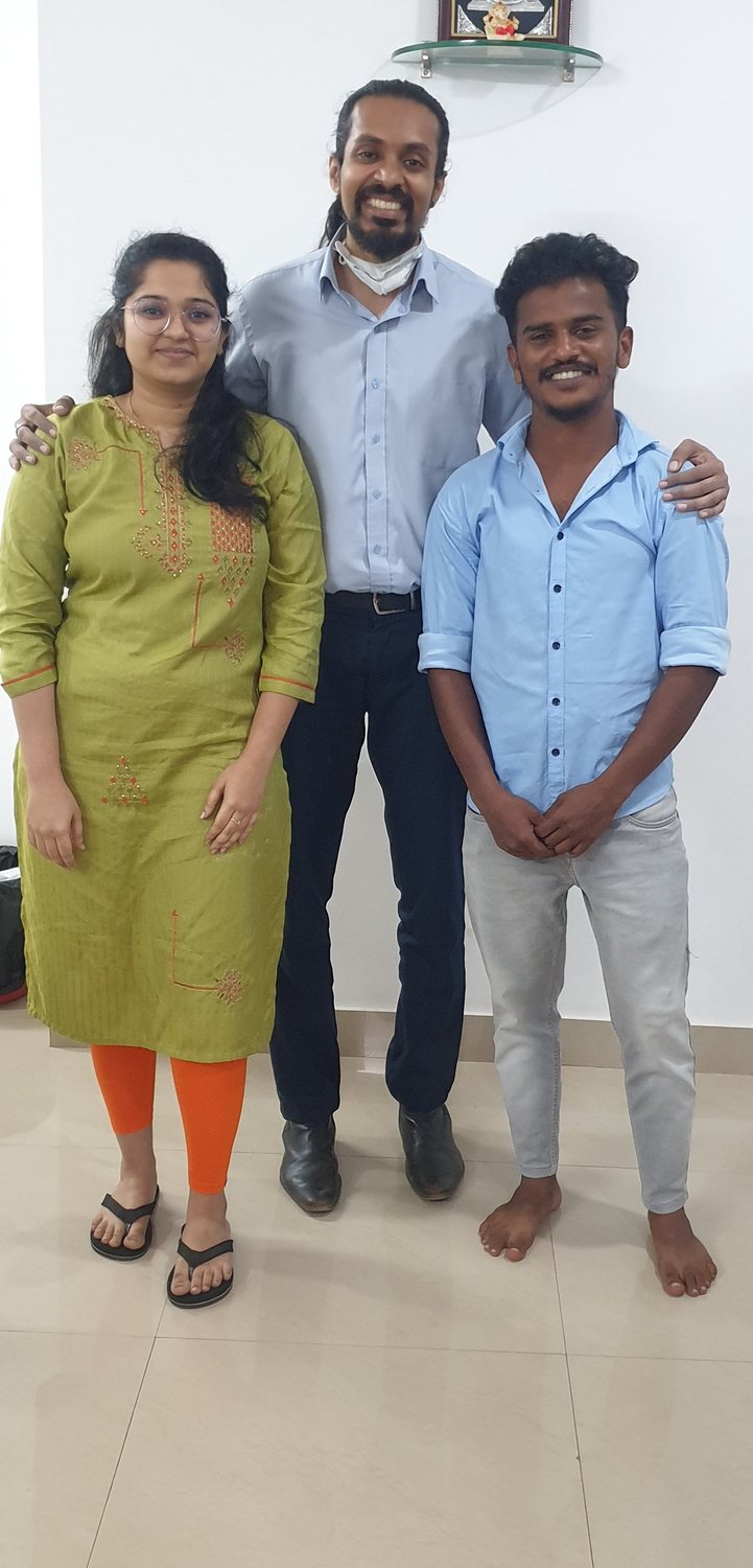 Dr. Keerthan with a patient and a family member