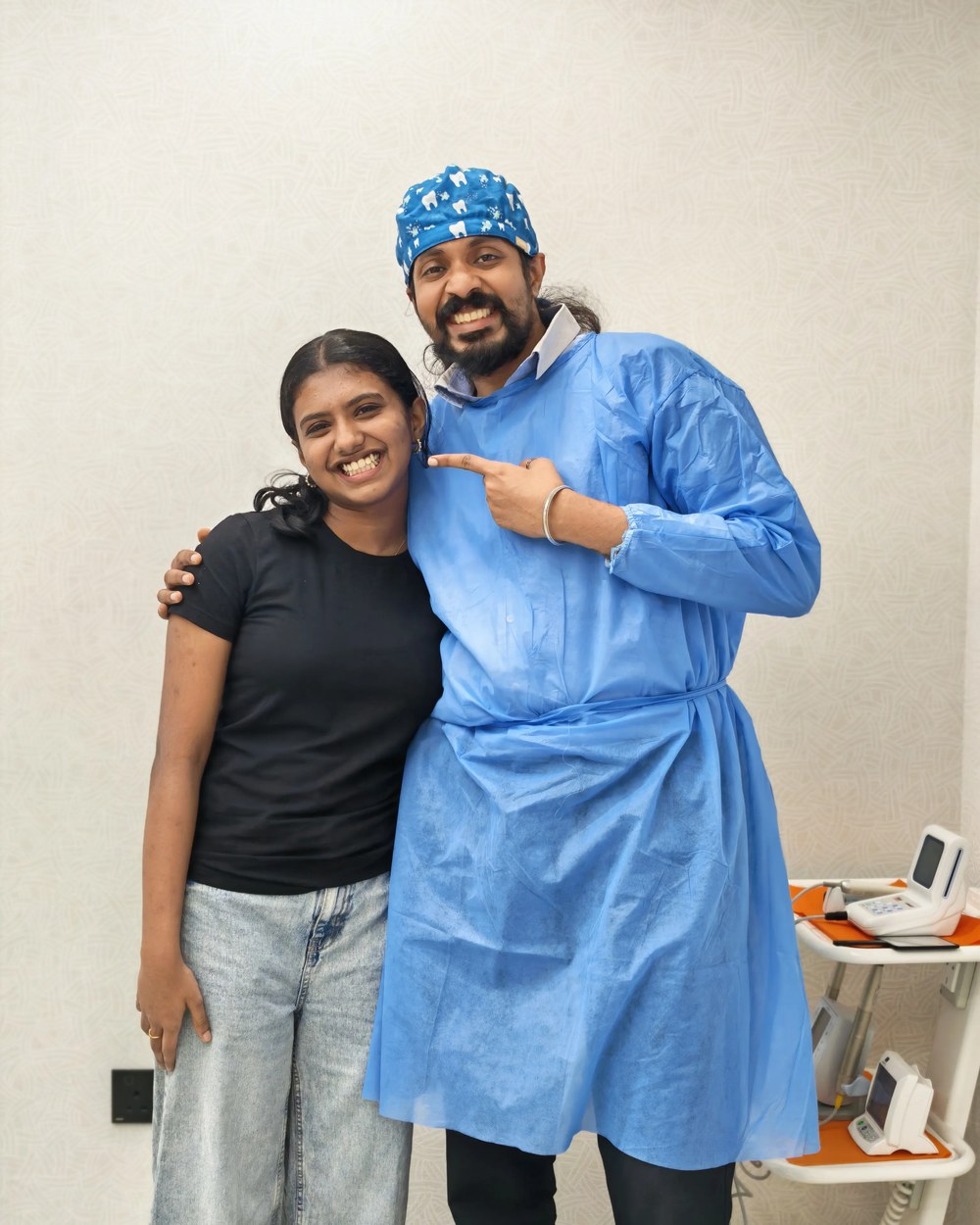 Dr. Keerthan with a smiling patient, pointing and laughing together