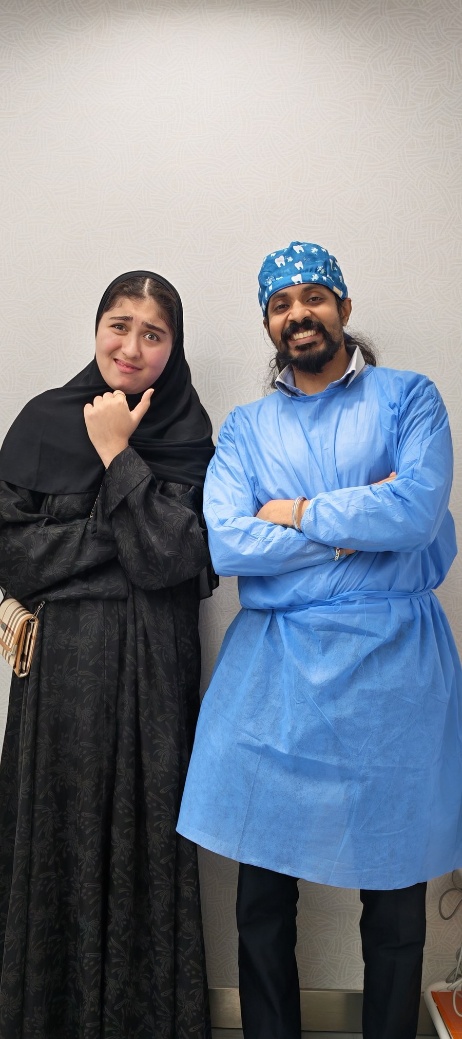 Dr. Keerthan with a patient, sharing a playful moment