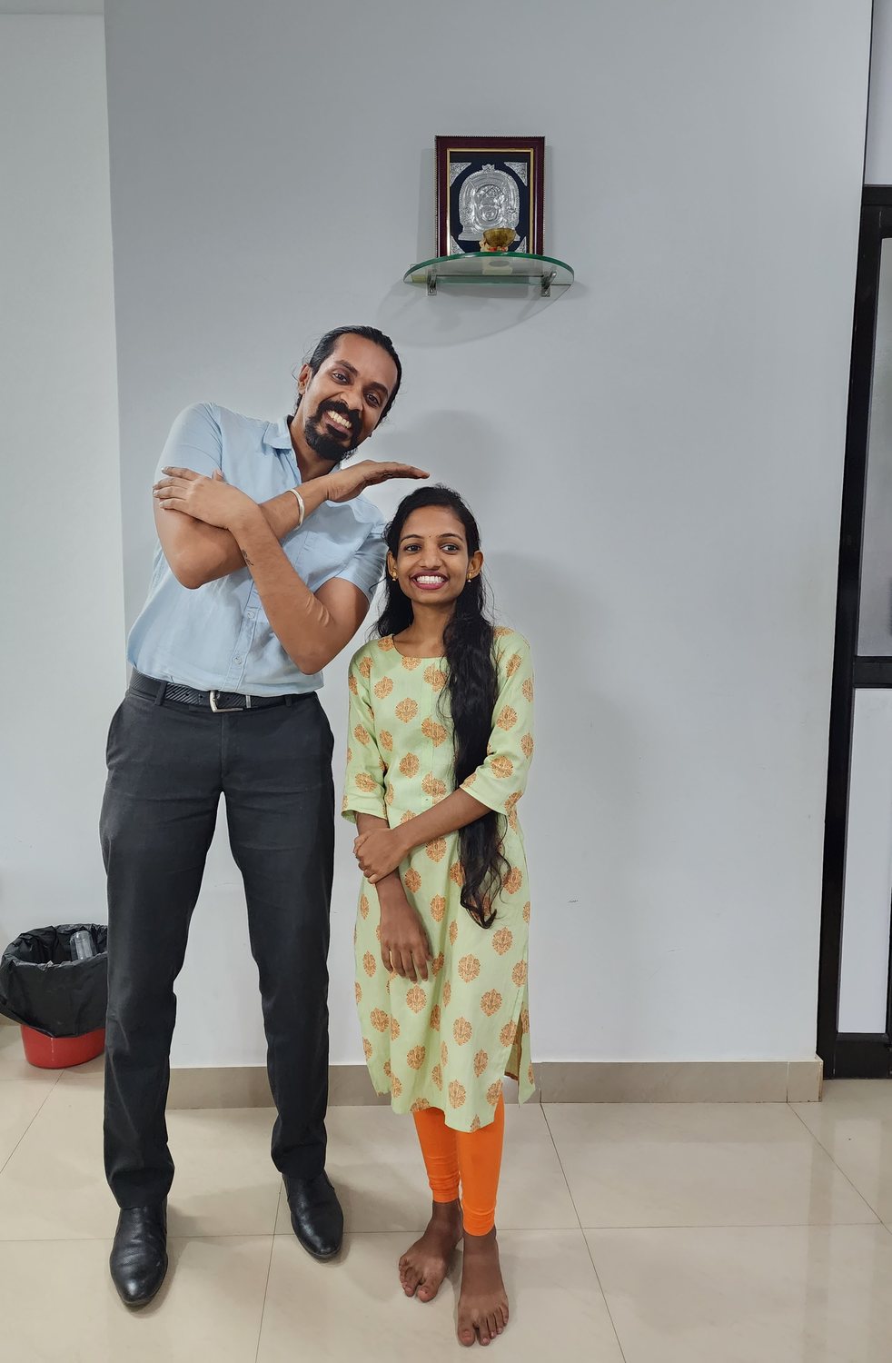 Dr. Keerthan with a patient on their last day of treatment