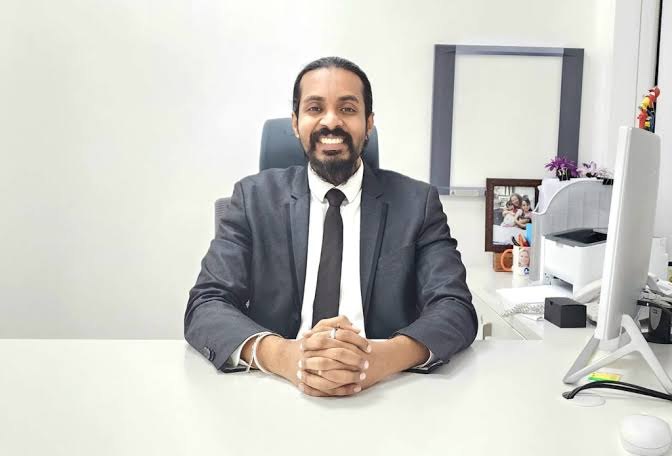 Dr. Keerthan Shashidhar at his desk